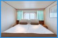 An old Holland America cruise ship is turning residential, letting travelers live at sea for $8,000 a month while it circumnavigates the globe